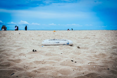 People on beach against blue sky