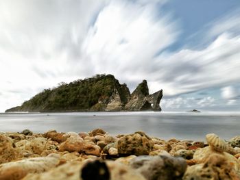 Rocks on beach against sky