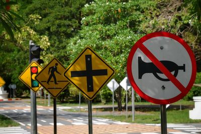 Road sign against trees