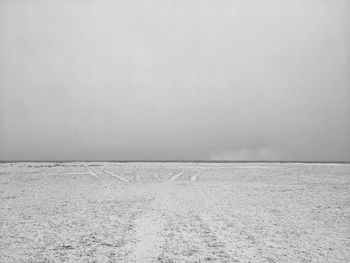 Scenic view of snow covered land against clear sky