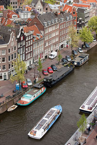 High angle view of boats moored in river in city