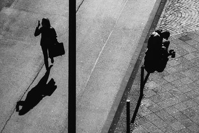 Shadow of people on road