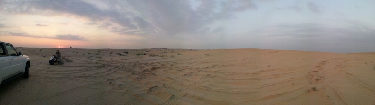 sand, beach, sky, lifestyles, leisure activity, sea, scenics, cloud - sky, tranquil scene, beauty in nature, shore, tranquility, vacations, men, tourist, nature, horizon over water, tourism, cloudy