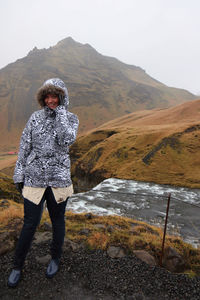 Full length of man standing on mountain against sky