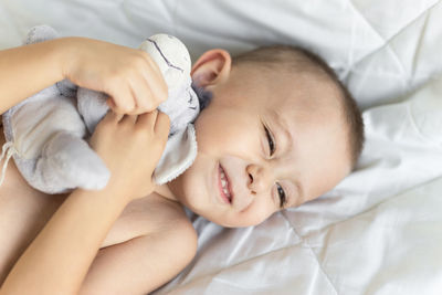 High angle view of baby sleeping on bed