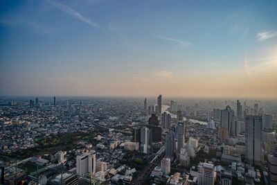 Aerial view of city buildings during sunset