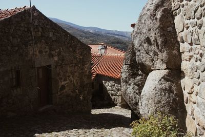 Stone wall of old building against sky