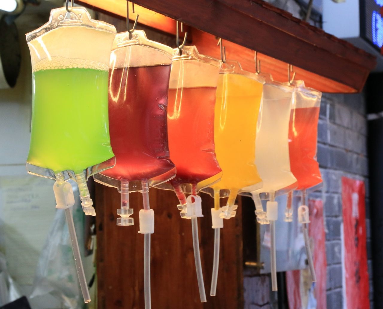 food and drink, drink, hanging, no people, drinking straw, refreshment, variation, cold temperature, close-up, drinking glass, focus on foreground, red, freshness, outdoors, day, multi colored