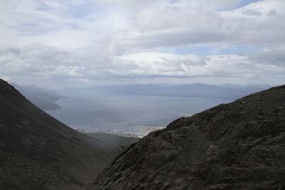 Scenic view of mountains against cloudy sky