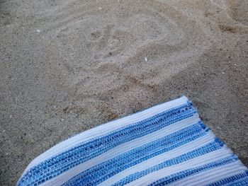 High angle view of shoes on sand at beach