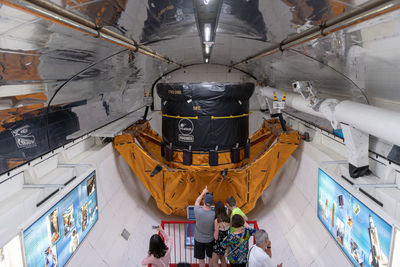 High angle view of people standing on ceiling