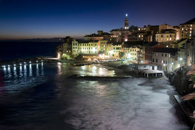 Canal passing through city at night