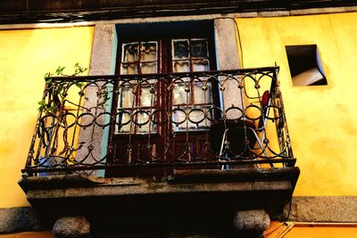 Low angle view of metal grate against building