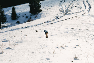 Man standing on snow covered land