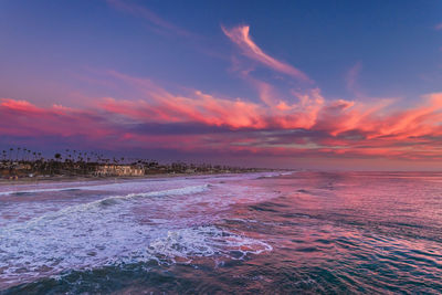 View over the ocean of the coastline with a red sunset