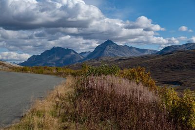 Scenic view of mountains against cloudy sky