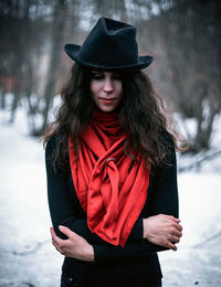 Woman wearing hat standing in snow