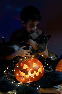 Close-up of a boy holding pumpkin