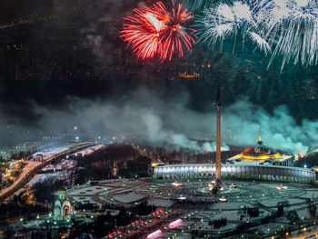 Firework display over city at night