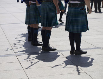 Low section of women standing on footpath