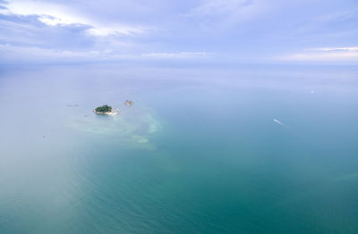 Distance shot of island amid calm blue sea