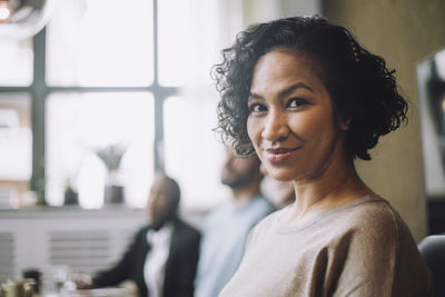 Portrait of smiling mature businesswoman in creative office