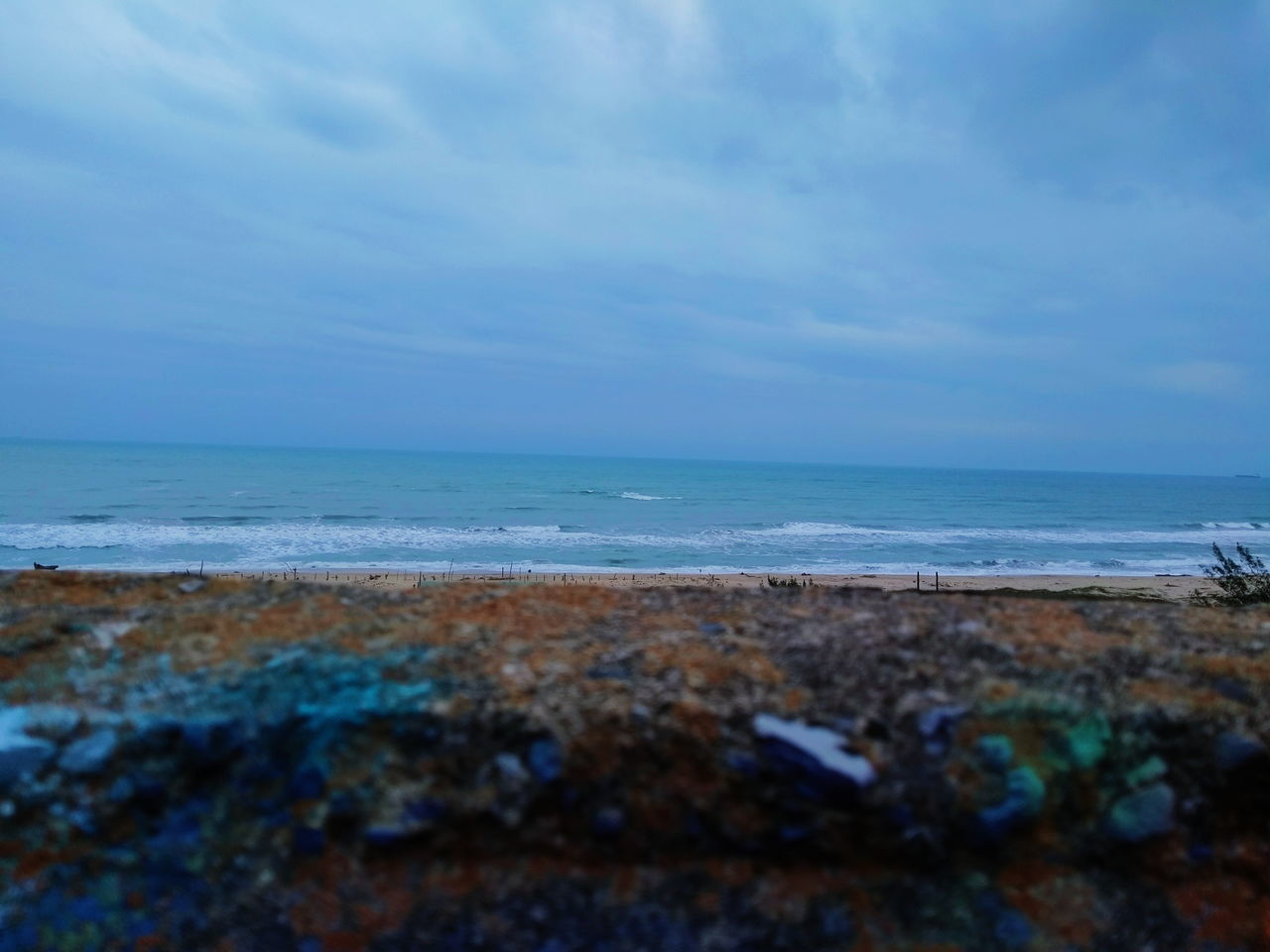 SCENIC VIEW OF BEACH AGAINST BLUE SKY