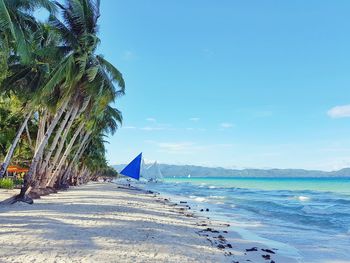 Scenic view of beach against blue sky