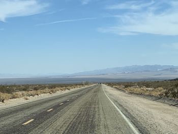 Empty road along countryside landscape