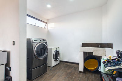 Laundry room, with washing machine, dryer, detergent area, hand washing sink,