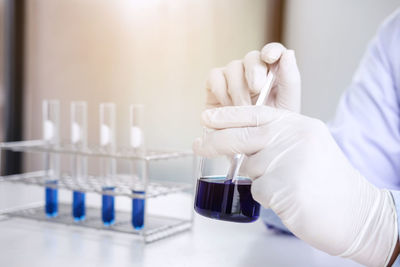 Cropped hand of scientist working in laboratory