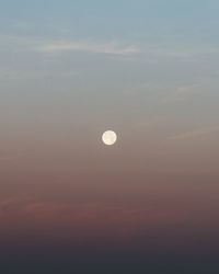 Low angle view of moon against sky at sunset