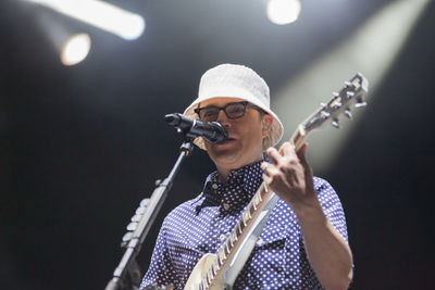Full length of senior woman holding umbrella