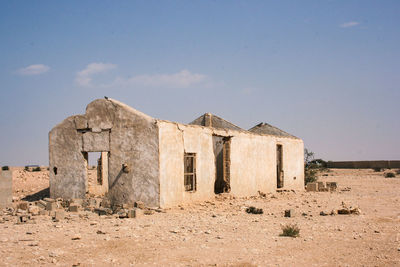 Old building on field against sky