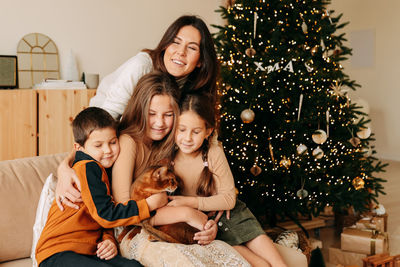 A large family celebrates christmas holidays in winter at home. mom with teenage children 