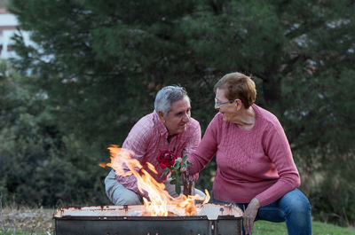 Rear view of two people on barbecue grill