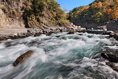 Scenic view of waterfall against sky