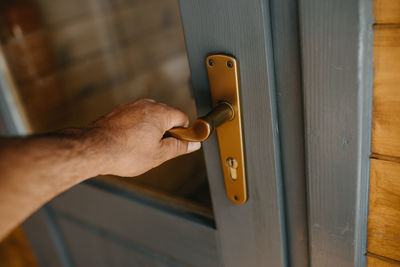 Close-up of hand holding door