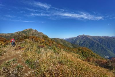 Scenic view of mountain range against blue sky