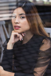 Businesswoman looking at camera in coffee shop, entrepreneur working outside office