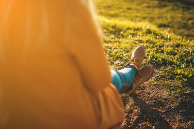 Low section of woman relaxing on garden