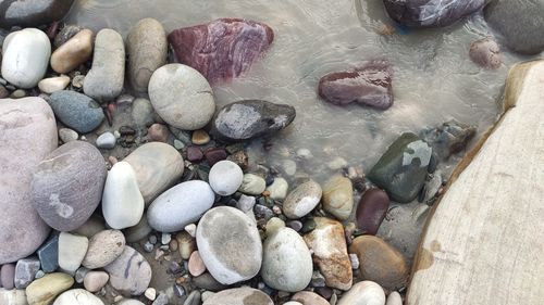 High angle view of pebbles on beach