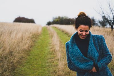 Woman standing on grassy field