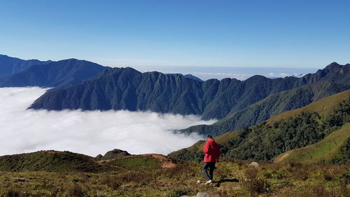 Woman on snowcapped mountains against sky