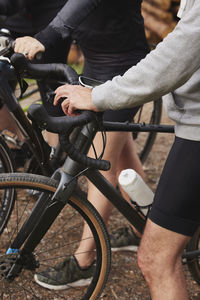 Friends cycling in forest