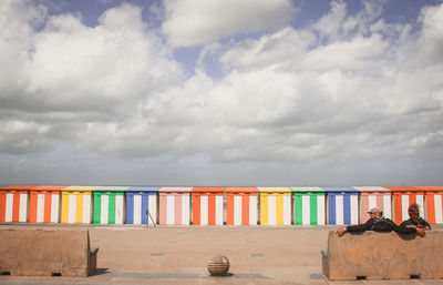 Multi colored umbrellas on beach against sky