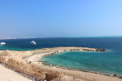 Scenic view of sea against clear blue sky