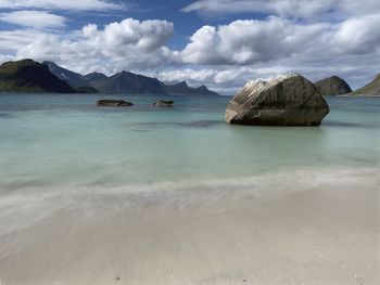Scenic view of sea and rock against sky in lofoten 