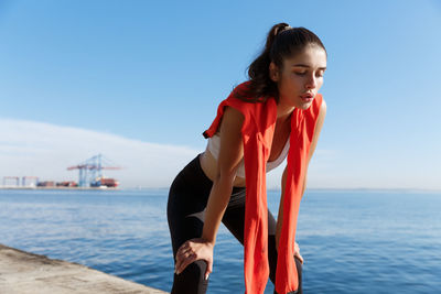 Young woman taking break during workout