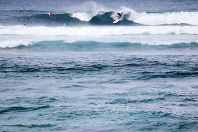 People surfing in sea